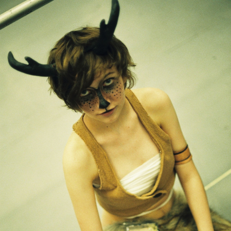 a girl with antlers extended